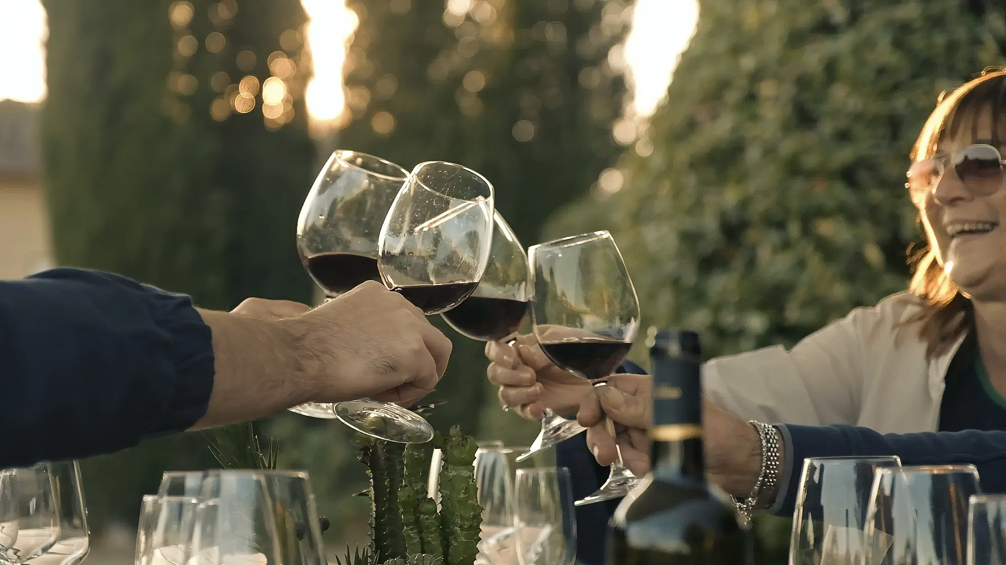 Close-up video frame of wine glasses clinking in a toast at La Marronaia, captured by Memento Agency – promotional hospitality footage