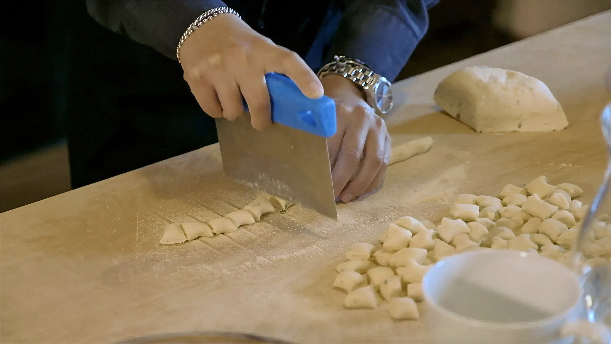 Close-up video frame of hands preparing traditional Tuscan food, captured for La Marronaia by Memento Agency – promotional culinary footage