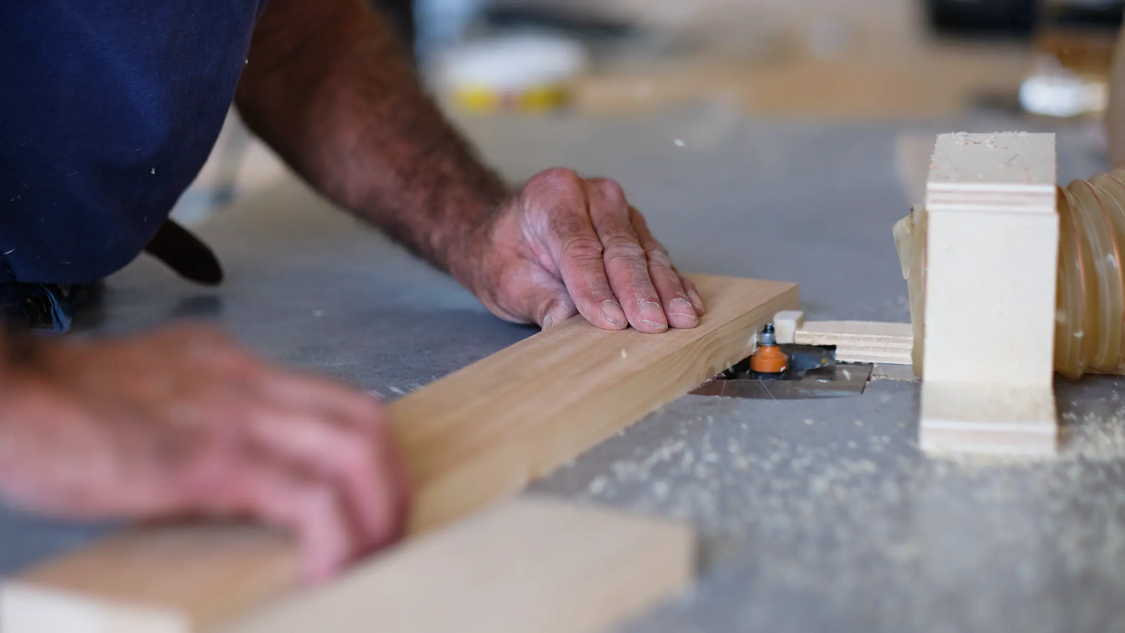 Close-up industrial photography of hands working on door production at Trezeta company – skilled craftsmanship detail