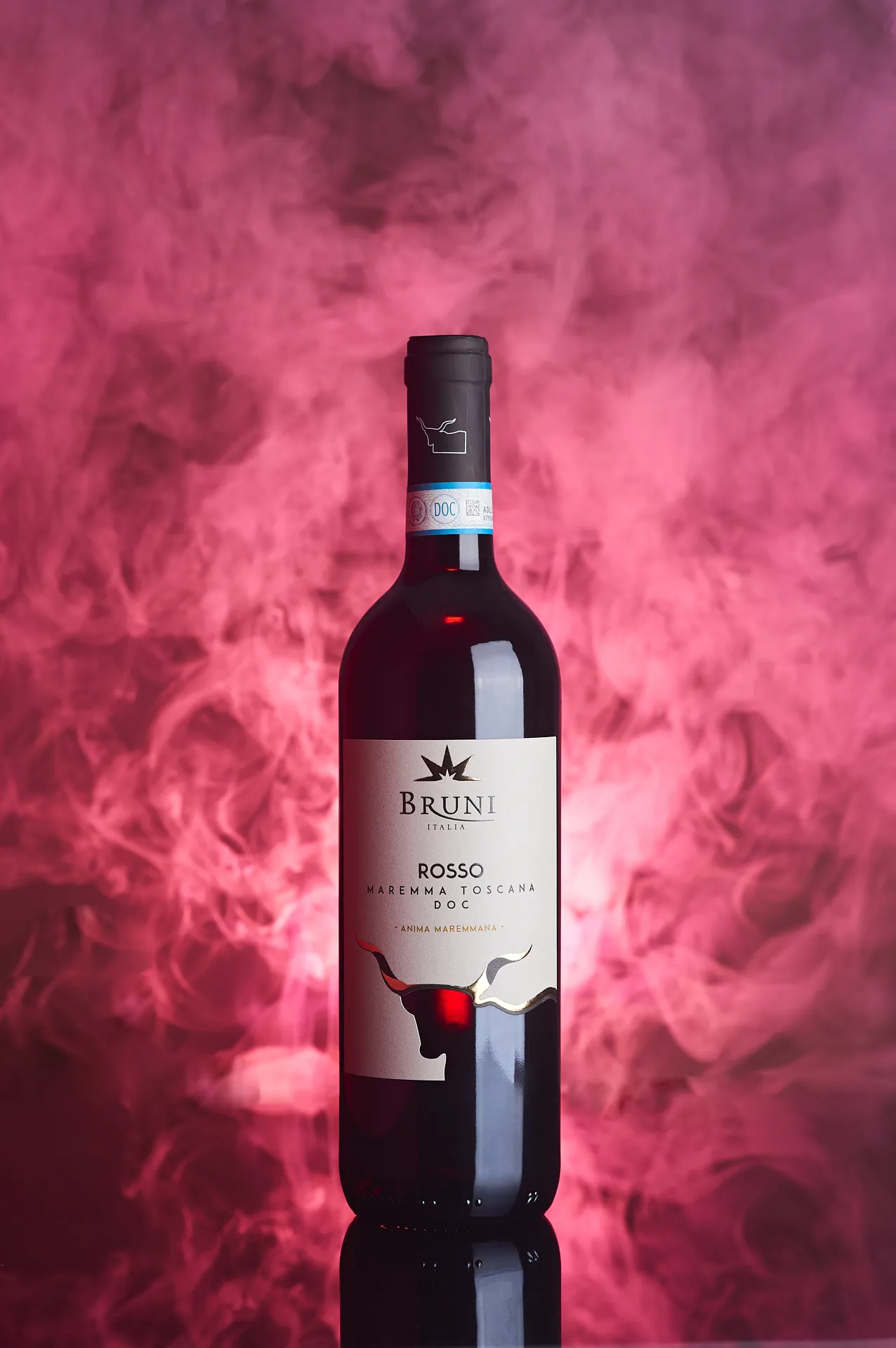 Ambient still life photo of Maremma Toscana DOC wine bottle with red backlighting and smoke on blackbackground – elegant Tuscan wine photography