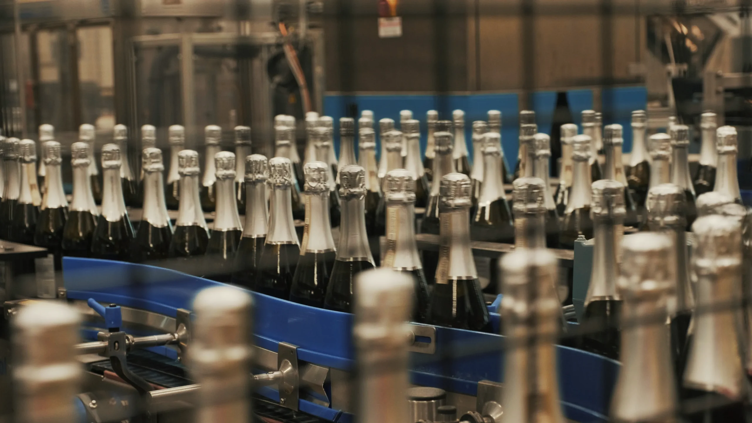 Video frame showing the wine bottling process inside the Val d'Oca facility, captured for Kiwitron by Memento Agency – industrial promotional footage