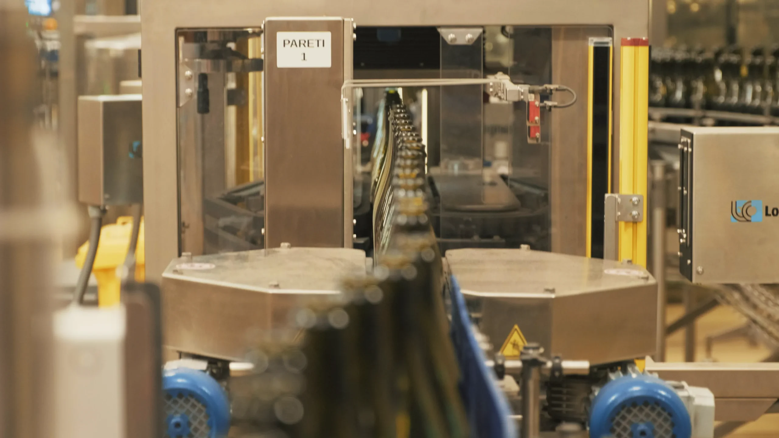 Video frame showing the wine bottling process inside the Val d'Oca facility, captured for Kiwitron by Memento Agency – industrial promotional footage