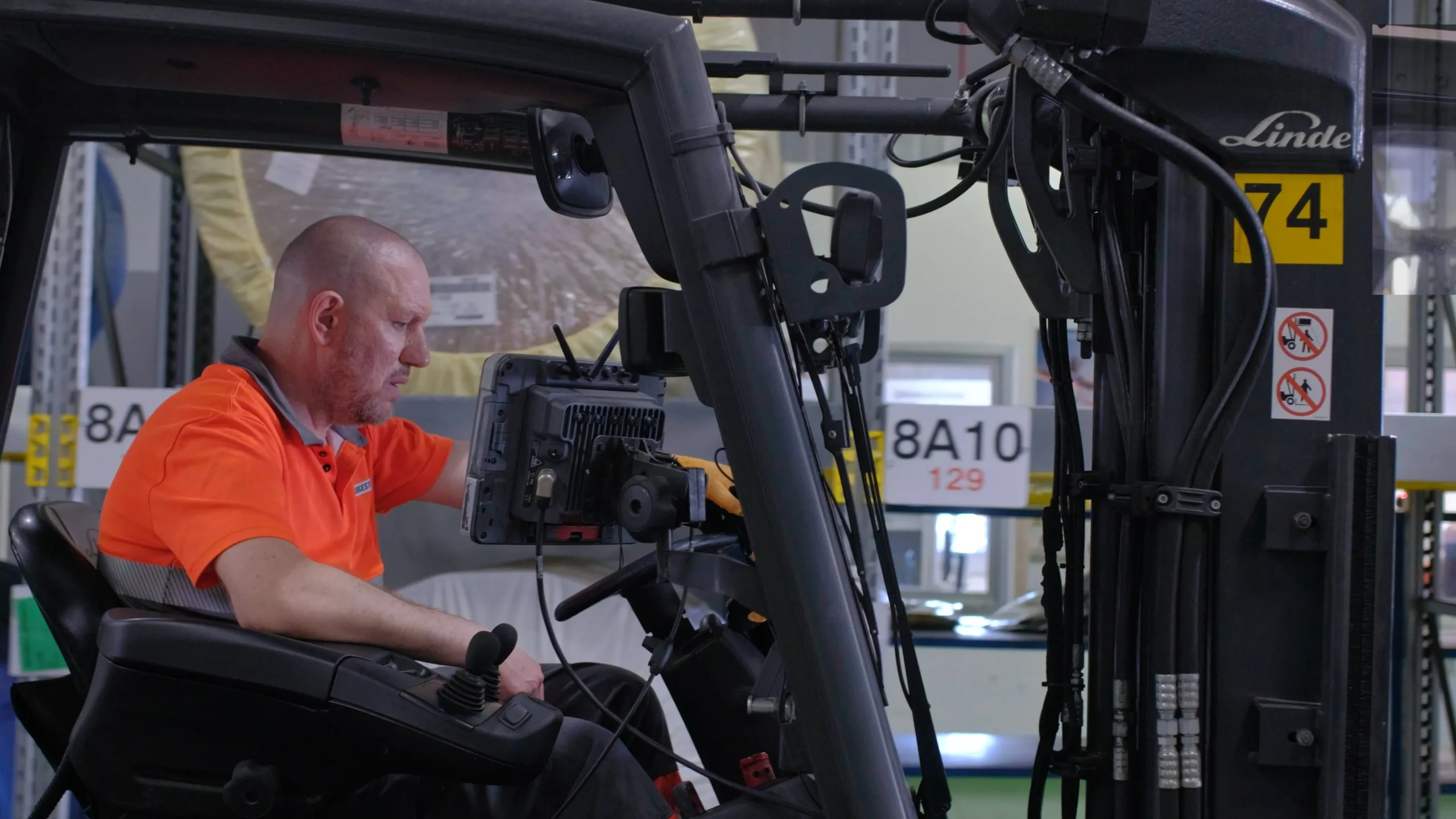 Video frame of a man driving a forklift inside the Bridgestone Italia facility, captured for Kiwitron by Memento Agency – industrial promotional footage