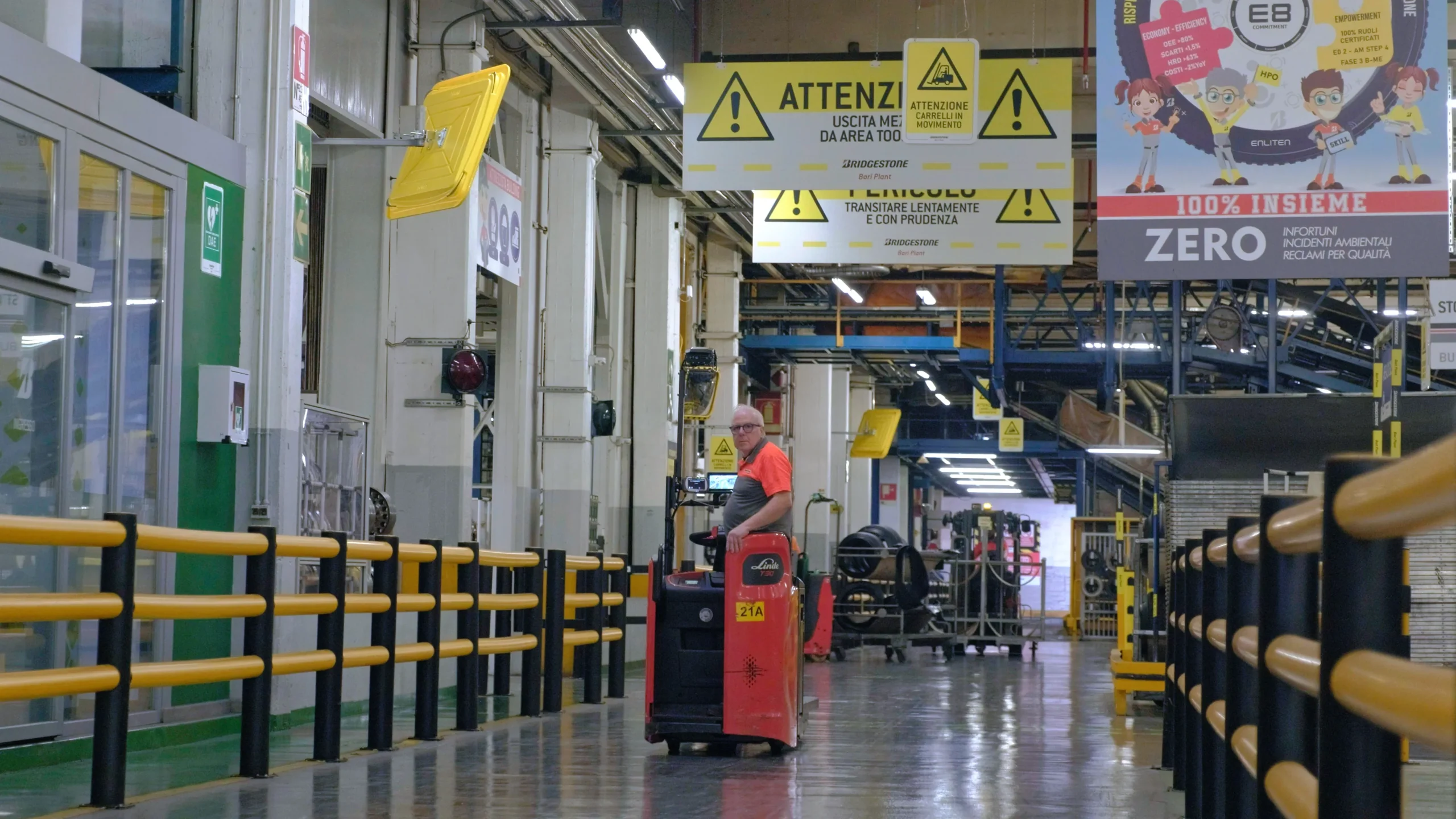 Video frame of a man driving a forklift inside the Bridgestone Italia facility, captured for Kiwitron by Memento Agency – industrial promotional footage
