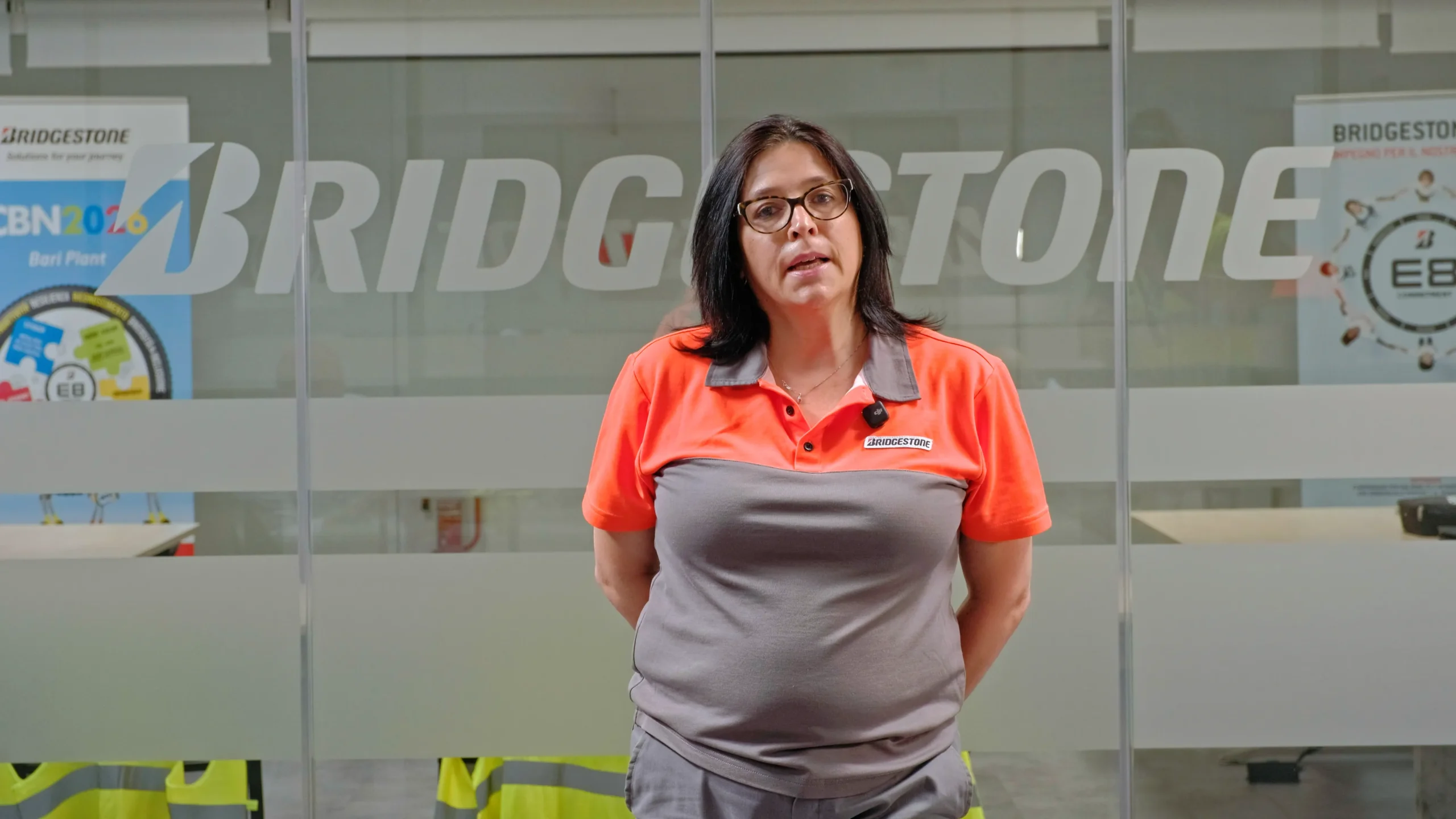 Video frame of a woman being interviewed at the Bridgestone Italia facility, captured for Kiwitron by Memento Agency – industrial promotional footage